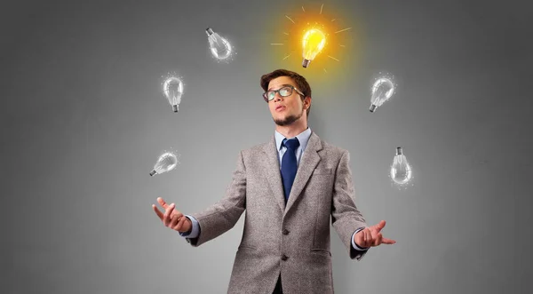 Happy person juggle with bulbs — Stock Photo, Image