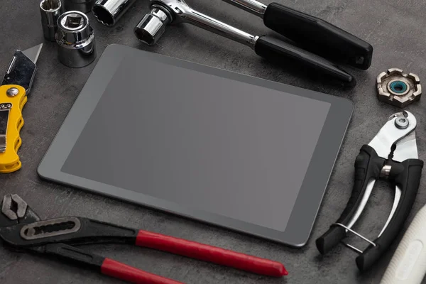 Бытовые инструменты и планшет с пустым экраном — стоковое фото