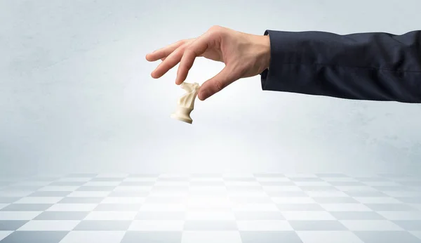 Большая рука делает следующий шаг в шахматной игре — стоковое фото