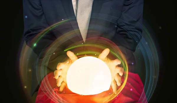 Man looking to the future of the word in a magic ball — Stock Photo, Image