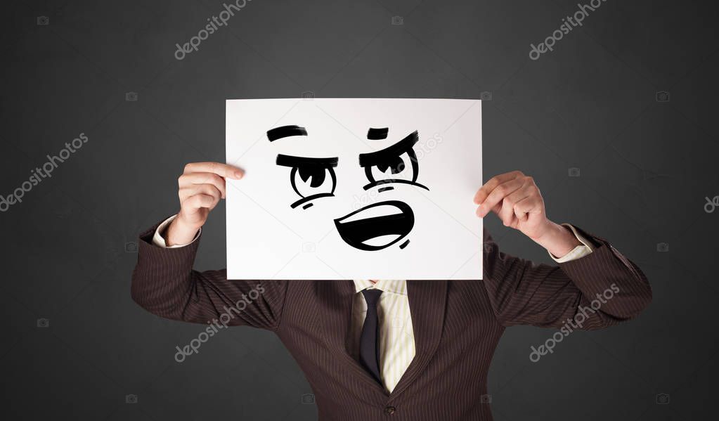 Person holding a paper with funny emoticon in front of her face