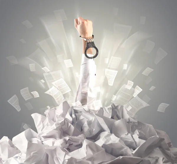 Hand coming out from paper pile — Stock Photo, Image