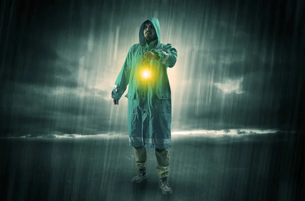 Man walking in storm with lantern