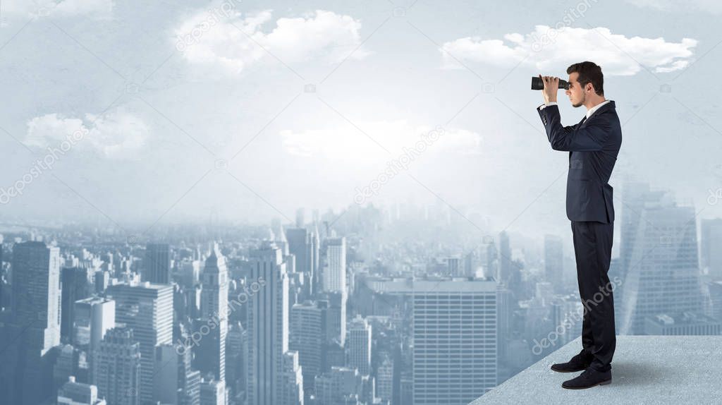 Man looking forward from the top of a skyscraper