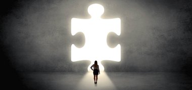 Woman standing in front of a big puzzle piece clipart