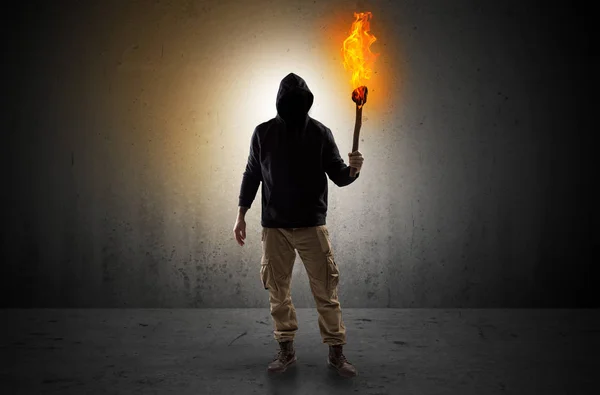 Man walking in an empty space with burning flambeau — Stock Photo, Image