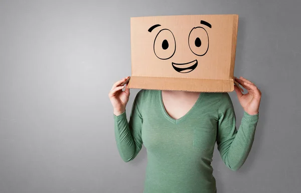 Woman with smiling carton box head — Stock Photo, Image