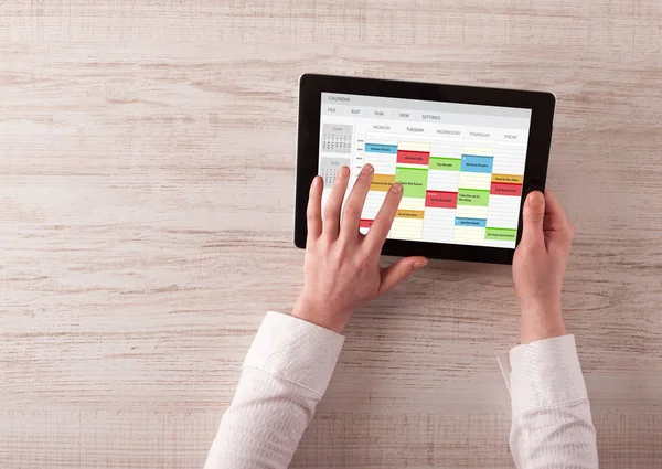 Hand holding tablet with timetable concept — Stock Photo, Image