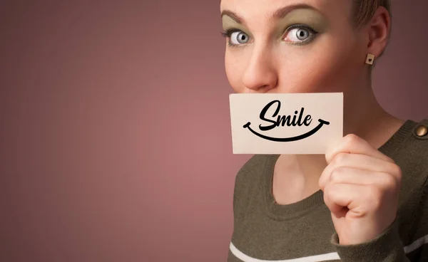 Person holding card with smile