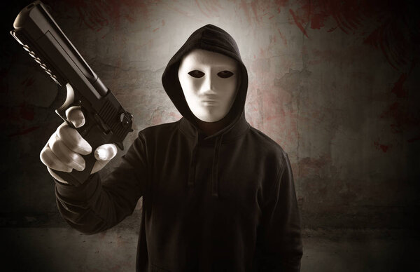 Armed assassin in an empty bloody room concept