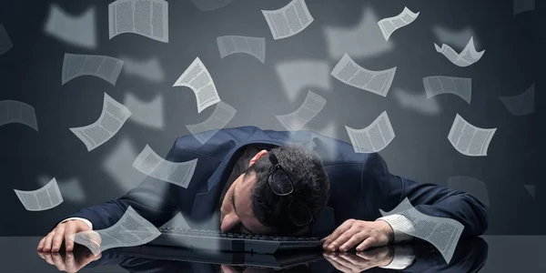 Businessman fell asleep at the office with paperwork concept