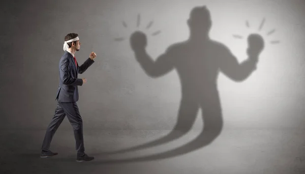 Businessman fighting with his unarmed shadow — Stock Photo, Image
