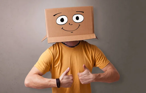 Young boy with happy cardboard box face — Stock Photo, Image