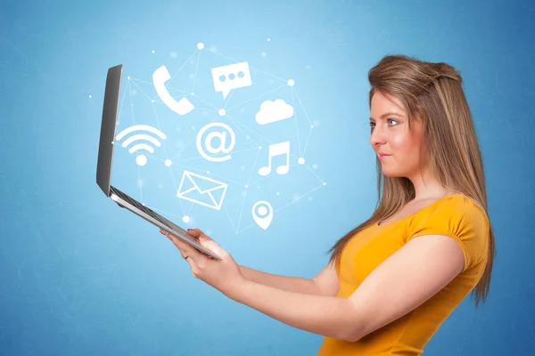Жінка тримає ноутбук з онлайн символами — стокове фото