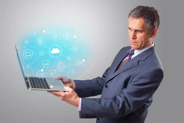 Man holding laptop with cloud based system concept — Stock Photo, Image