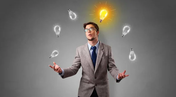 Happy person juggle with bulbs — Stock Photo, Image