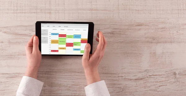 Hand holding tablet with timetable concept — Stock Photo, Image