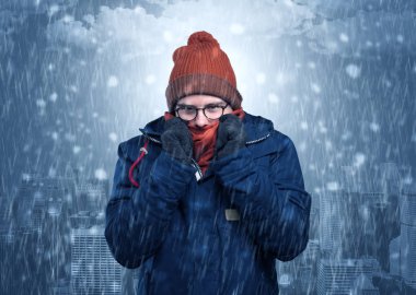 Boy freezing in cold weather with city concept clipart