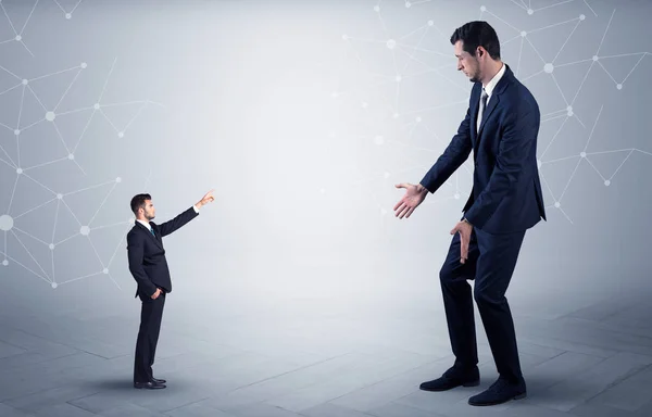 Small man aiming at a big man with network concept — Stock Photo, Image