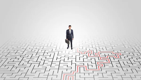 Young entrepreneur standing in a middle of a labyrinth — Stock Photo, Image