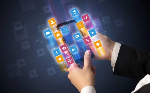 Hand using smartphone with angular app icons — Stock Photo, Image