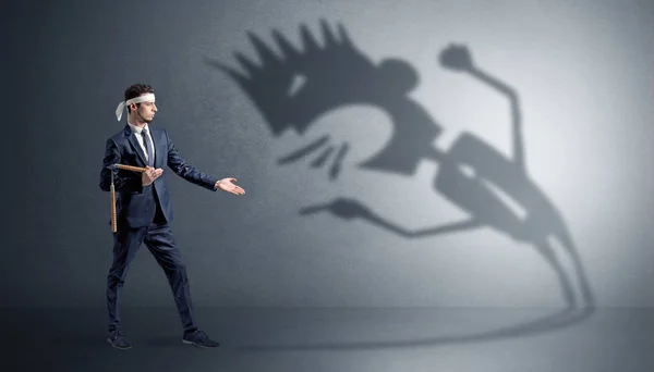 Karate man fighting with a big scary shadow — Stock Photo, Image