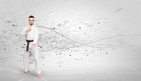 Karate man doing karate tricks with chaotic concept — Stock Photo, Image