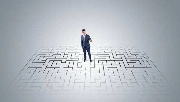 Businessman standing in a middle of a maze — Stock Photo, Image