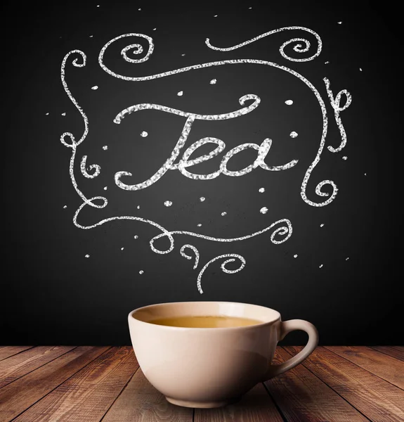 Steaming cup of tea with white doodles — Stock Photo, Image
