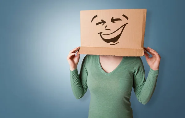 Young girl with happy cardboard box face — Stock Image Young girl with happy cardboard box face Stock Photo