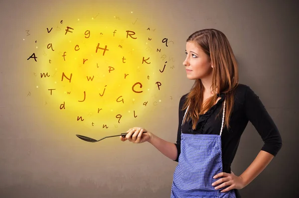 Person cooking letters in wok — Stock Photo, Image