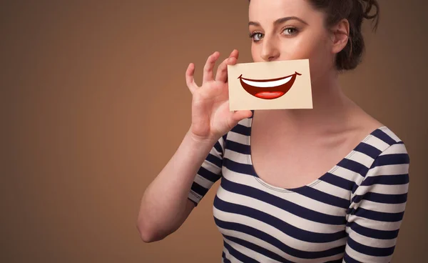 Person holding card in front of his mouth — Stock Photo, Image