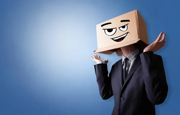 Young man  with cardboard box on his head — Stock Photo, Image