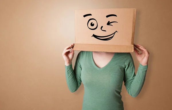 Молодая женщина со счастливым лицом из картонной коробки — стоковое фото