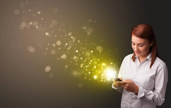 Using phone with gold sparkling concept — Stock Photo, Image