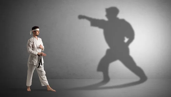 Karate man confronting with his own shadow — Stock Photo, Image