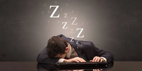 Businessman fell asleep at the office on his keyboard Stock Photo