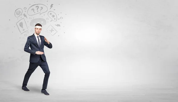 Businessman fighting with doodled symbols concept — Stock Photo, Image