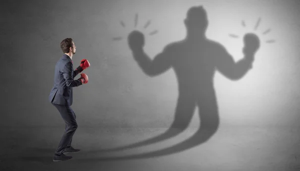 Businessman fighting with his unarmed shadow — Stock Photo, Image