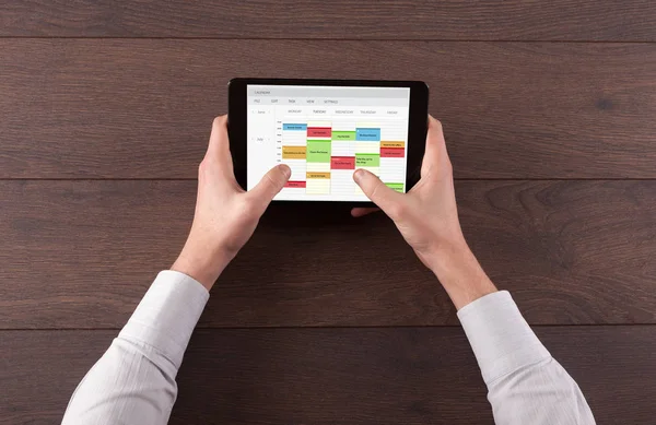Hand holding tablet with timetable concept — Stock Photo, Image