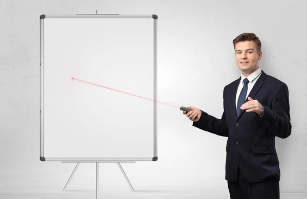 Businessman with laser pointer and copyspace white blackboard — Stock Photo, Image
