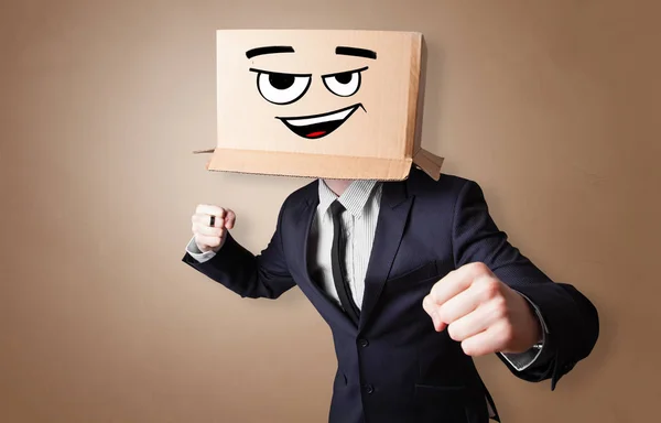 Young man with cardboard box on his head — Stock Photo, Image