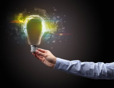 Koyu arkaplanda el ele tutuşan ampul