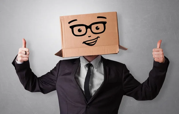 Молодой человек со счастливым лицом из картонной коробки — стоковое фото