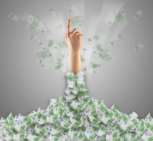 Hand buried in cash pile and trying to get out — Stock Photo, Image