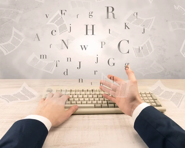 Elegant businessman hand typing with fluttering papers around