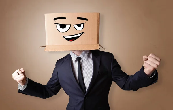 Young man with cardboard box on his head — Stock Photo, Image