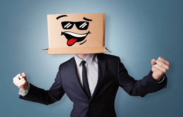 Young boy with happy cardboard box face — Stock Photo, Image