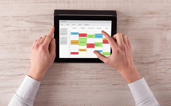 Hand holding tablet with timetable concept — Stock Photo, Image