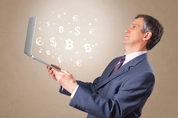 Man holding laptop with symbols — Stock Photo, Image